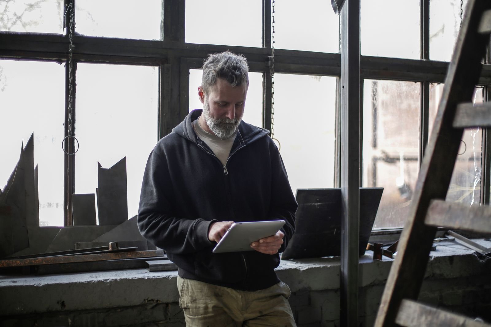 Auto shop owner in Florida reviewing Google Business Profile reviews on a tablet
