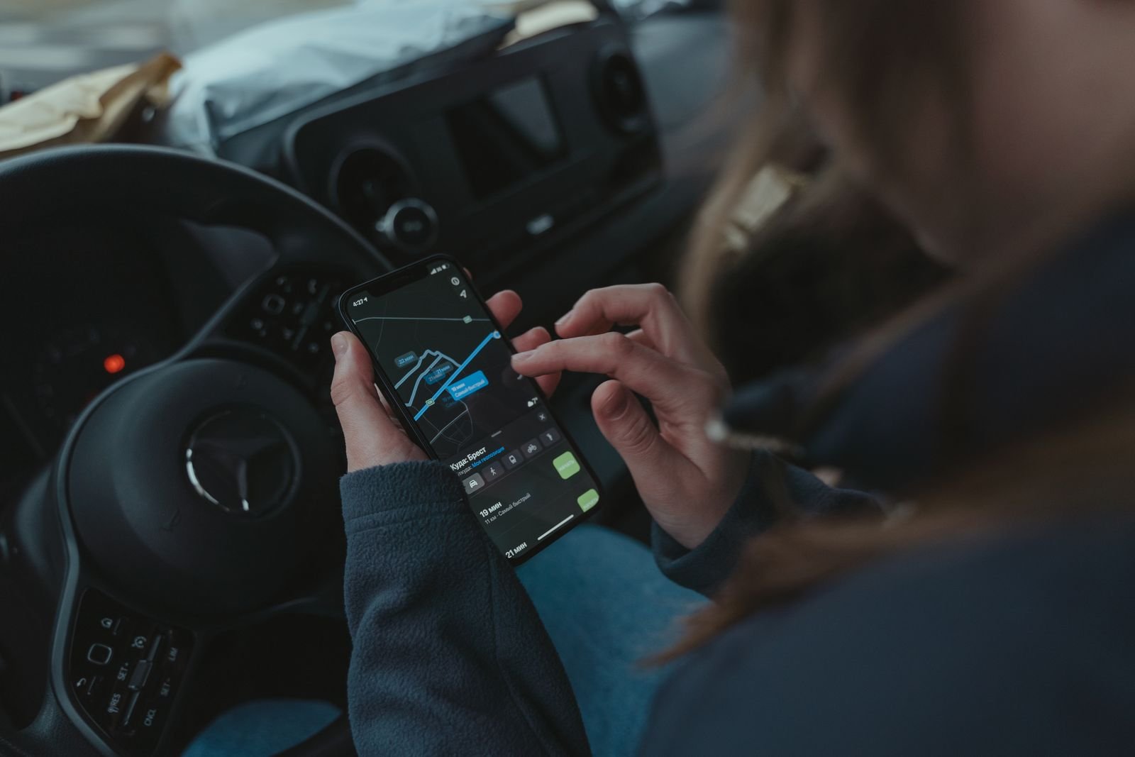 Person using a smartphone to compare exotic car rental options in Florida