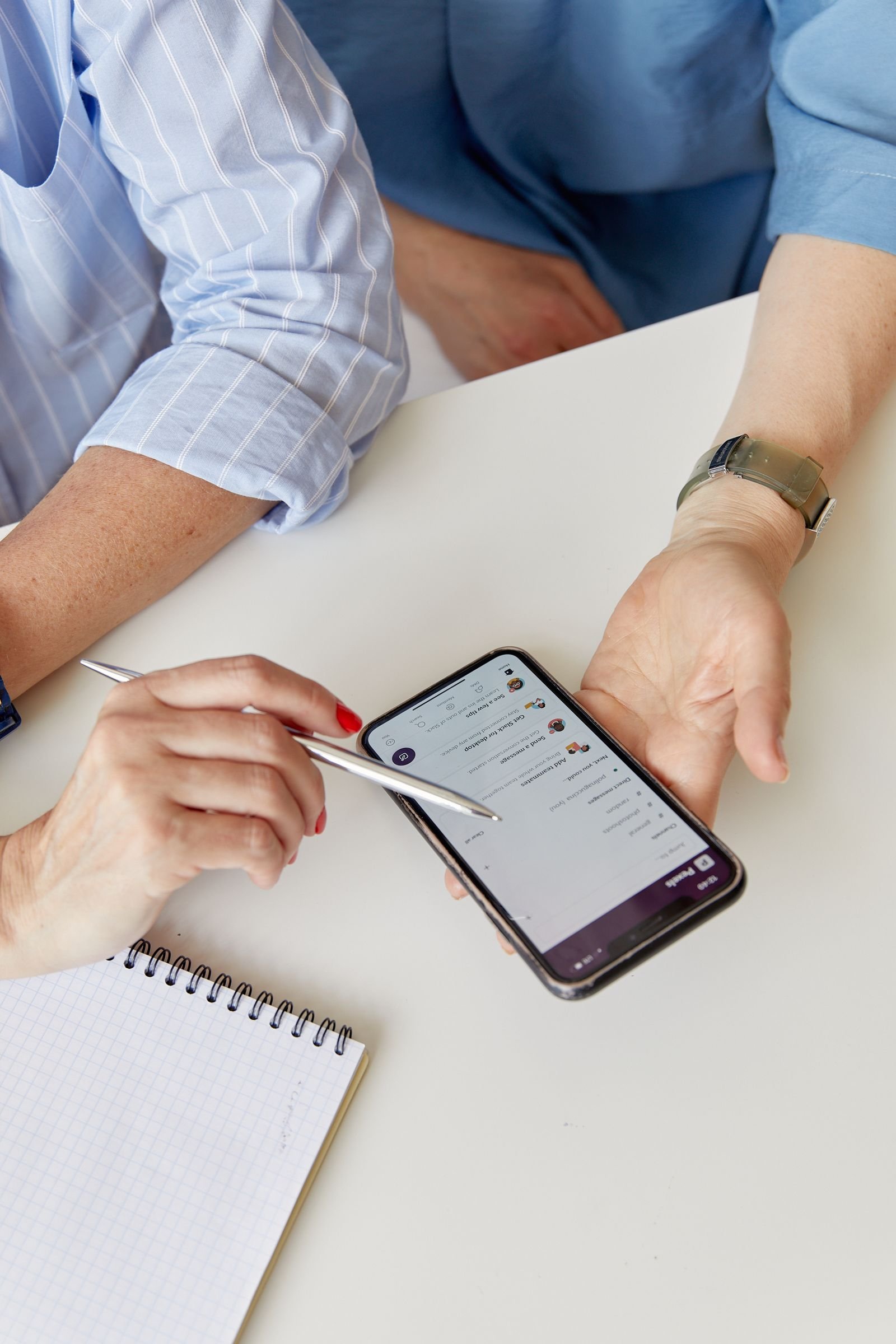 Customer holding a smartphone to write a Google review for a Florida detailing shop