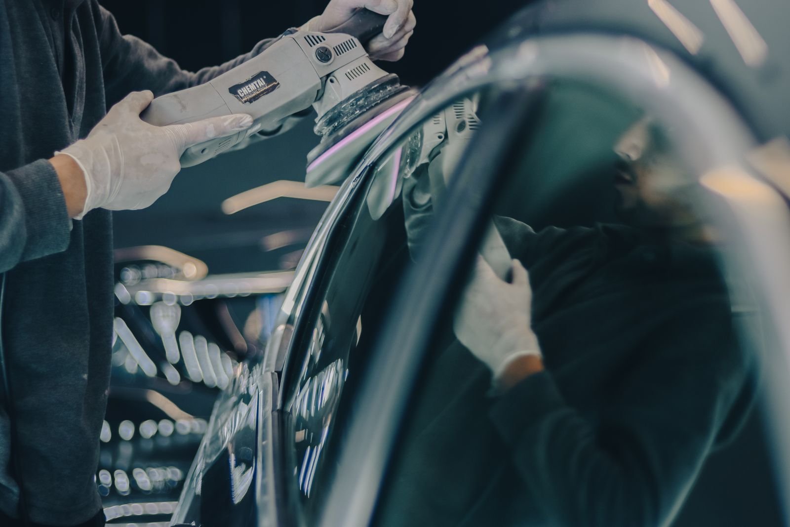 Detailer polishing a car to a mirror finish for a Florida before-and-after gallery