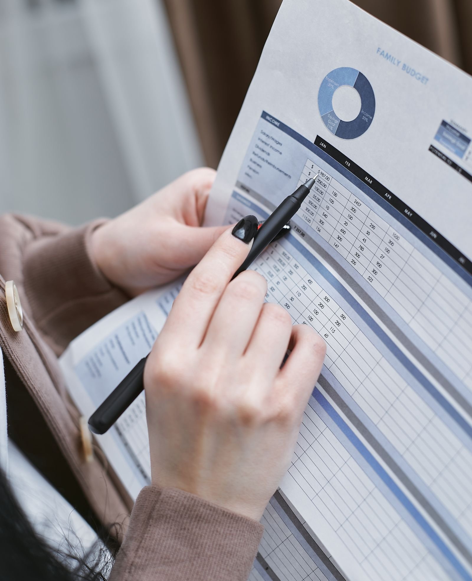 Shop owner writing out a PPC and SEO budget split on paper