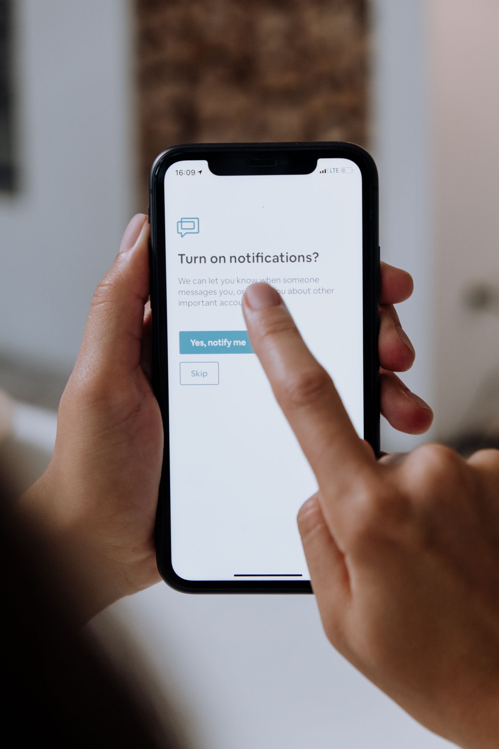 Customer holding a smartphone receiving an appointment reminder text