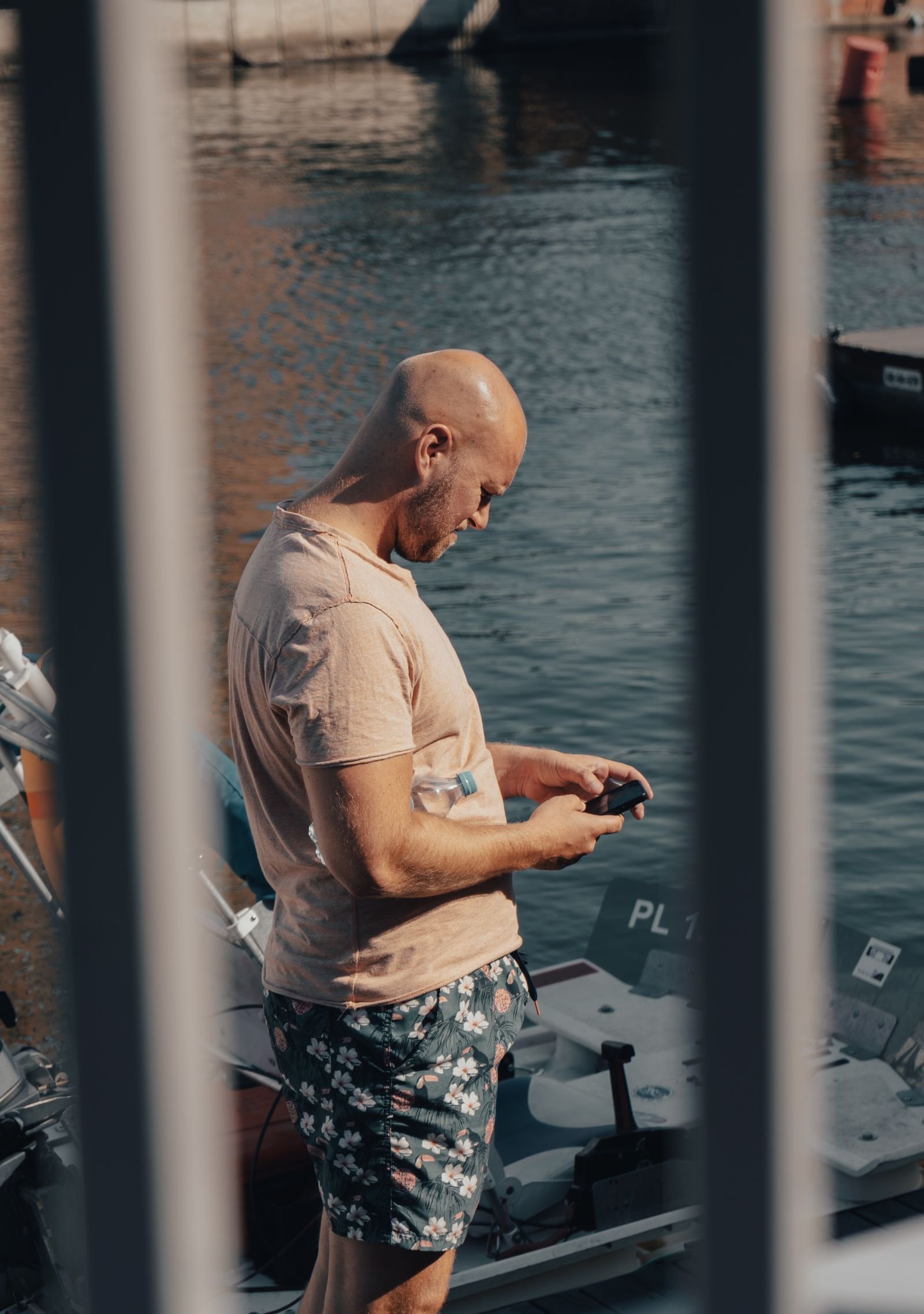 Customer booking a marine rental from a smartphone while standing at the marina