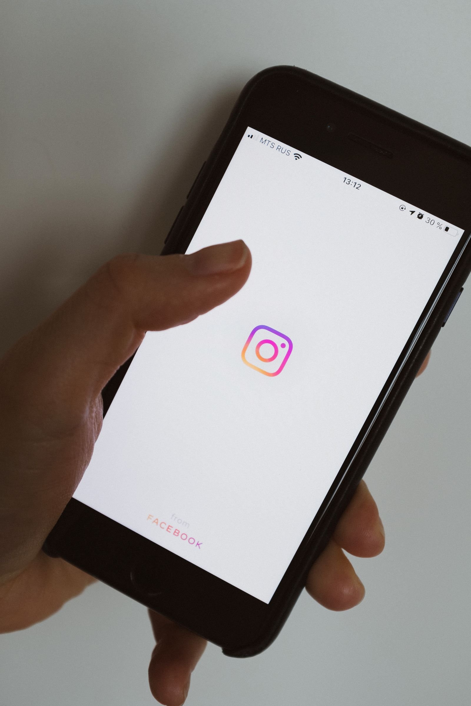 Person scrolling a social media feed on a smartphone looking at detailing content