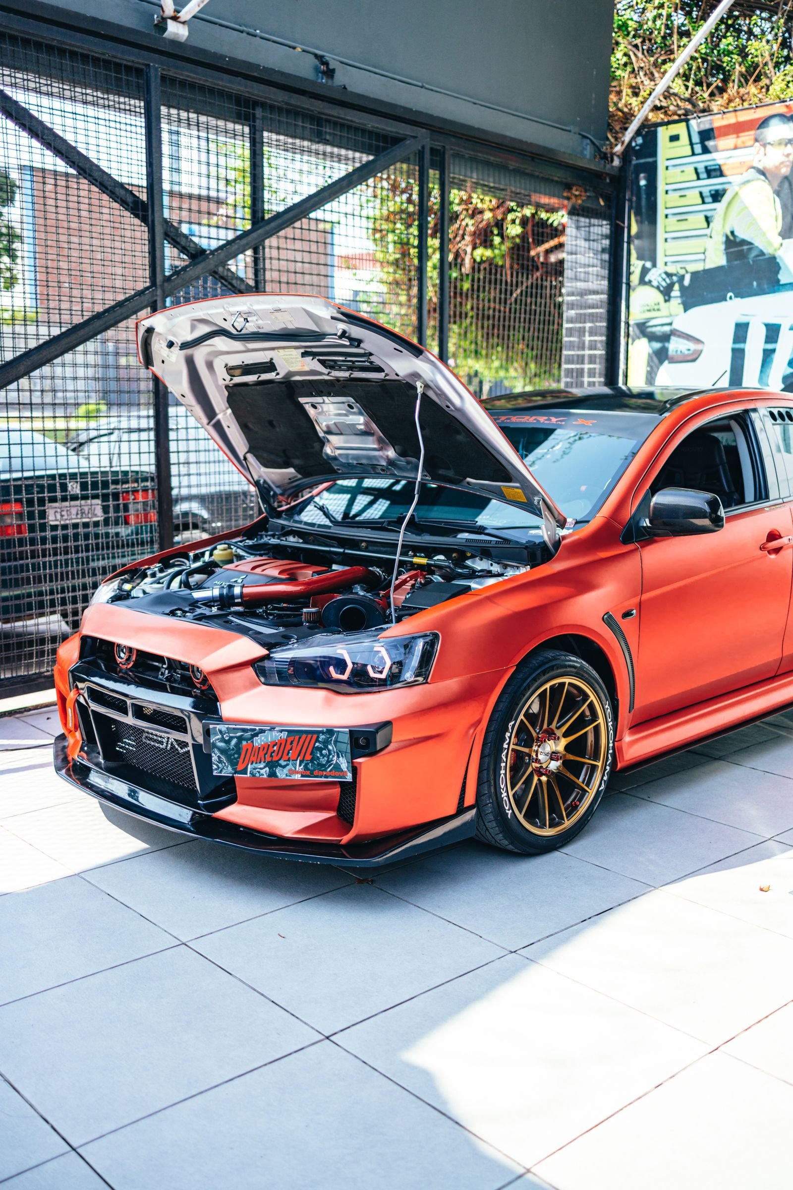 Custom performance car build with the hood open in a Florida garage
