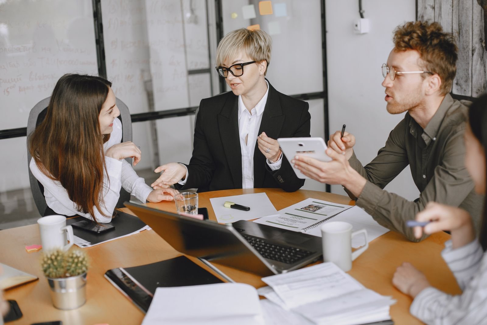 Business team discussing a fleet vehicle wrap contract in a conference room