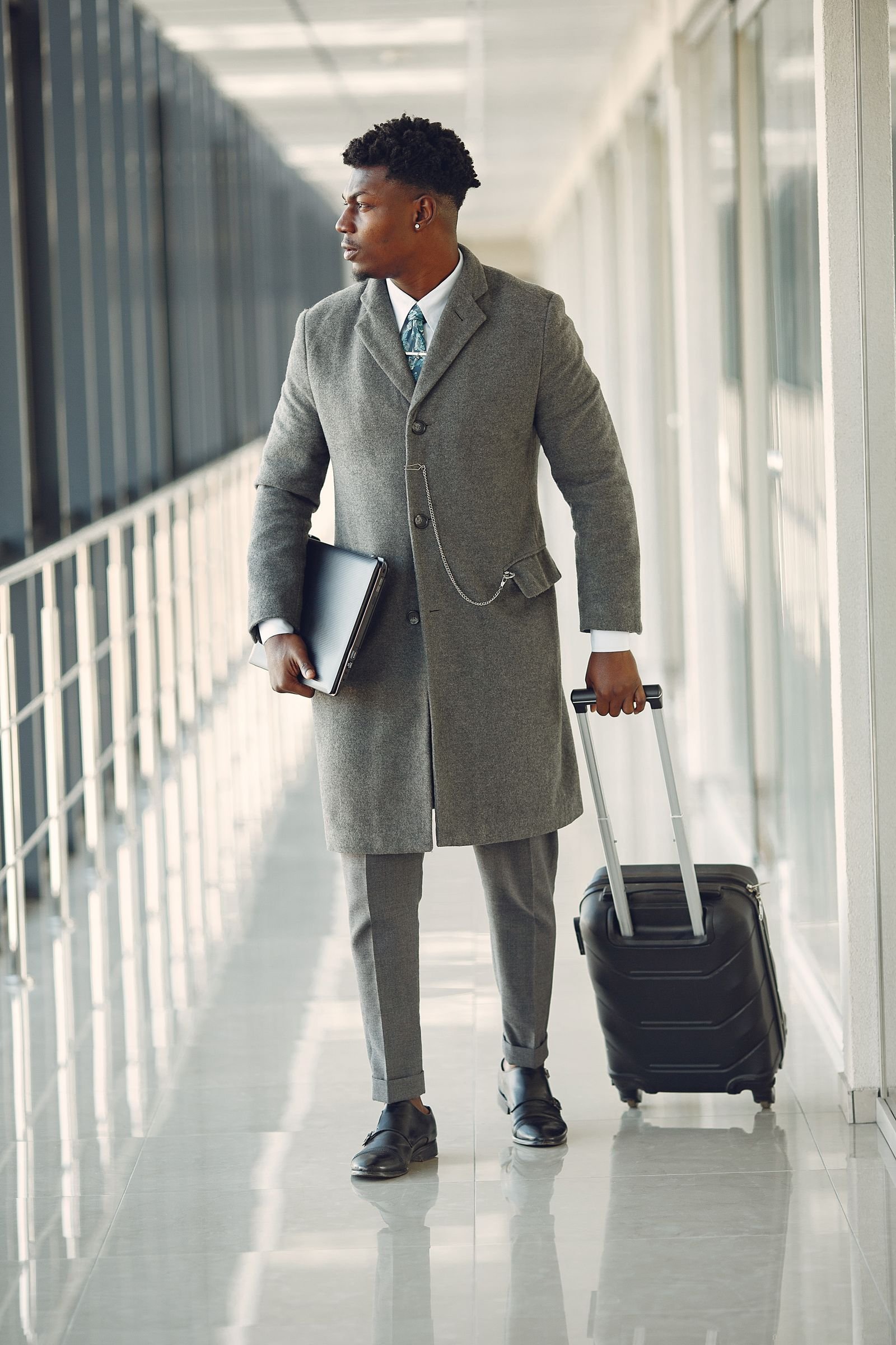 Corporate traveler walking through an airport hallway for a scheduled chauffeur pickup
