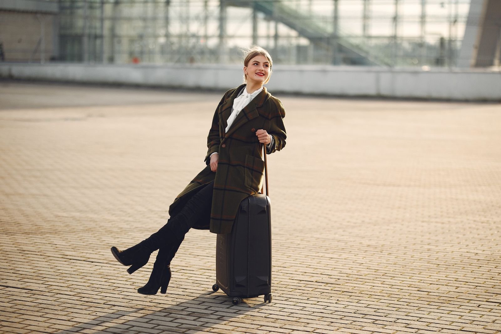 Traveler with a suitcase researching an exotic car rental in Miami Florida before a trip