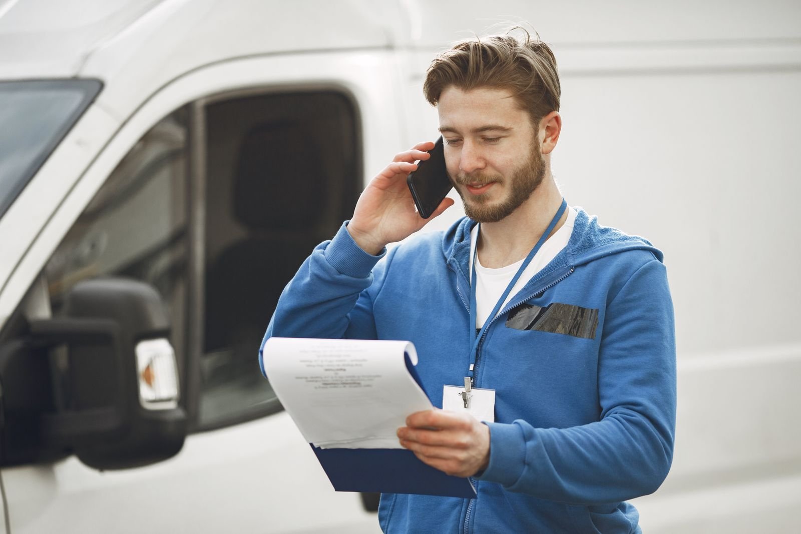 Mobile detailing technician checking appointment details on a smartphone in Tampa Florida