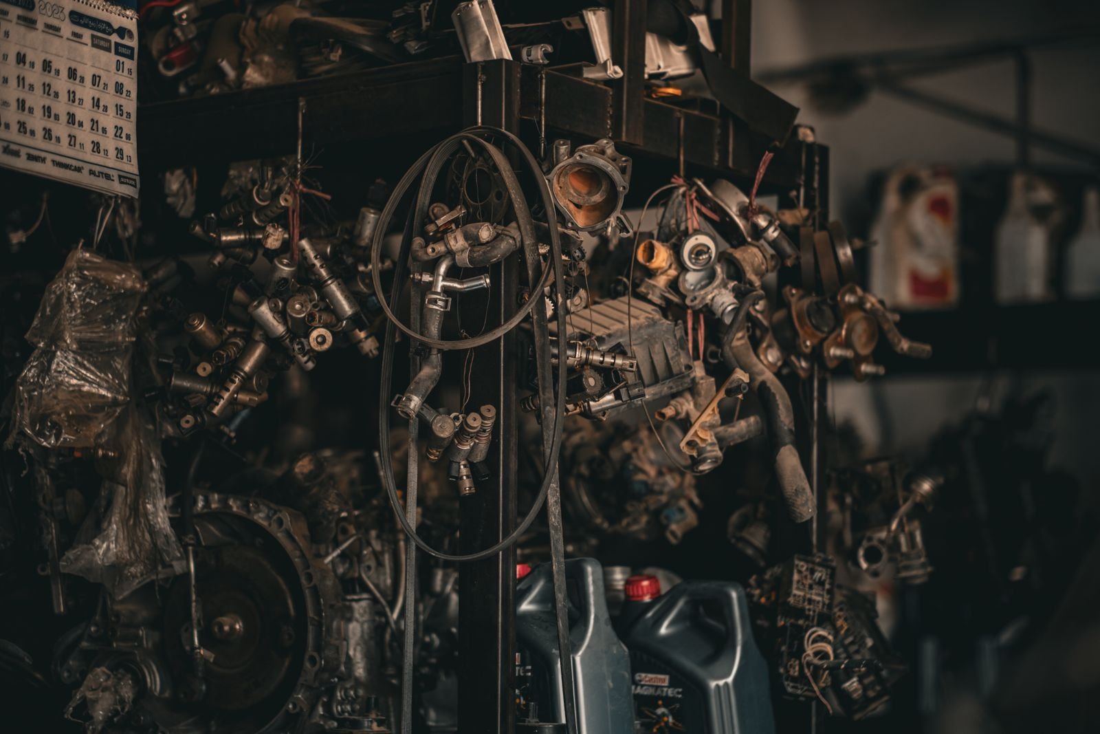 Mechanics working in a busy automobile workshop, sourcing parts suited to Florida vehicle fitment